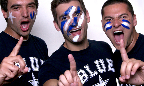 Members of the UIS Blue crew are shown with painted blue and white faces. 