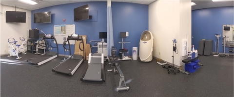 Exercise Physiology & Strength Lab looking at the cardio equipment and the Bod Pod in the right corner of the blue and white wall.
