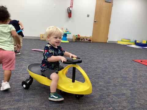 child riding scooter