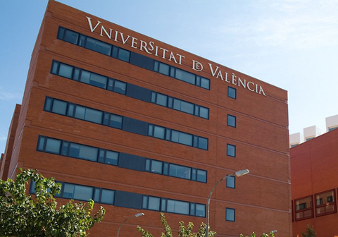 Red brick building with windows with University of Valencia sign on the top