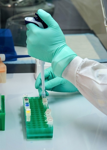 Pathology Lab with pathologist dropping sample into test tubes.