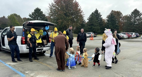 police department vehicle with toddlers trick-or-treating