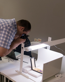 A student takes a photo of a historical artifact.