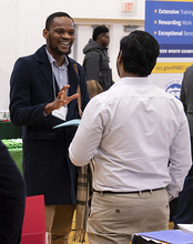 Student talking with employer at expo