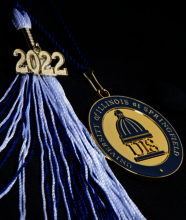 Black graduation cap with a blue and white 2022 tassle