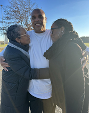 Brian Beals hugged by family members