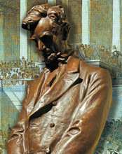 A bronze statue of Abraham Lincoln looking down.