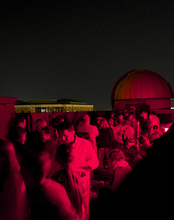 A crowd of people on the roof of Brookens Library for a Star Party.