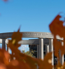 UIS colonnade in the background with autumn trees in the foreground