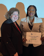 Aisha Katsina Isa receiving the Emerging Public Health Leader Award at the Illinois Public Health Association Conference.