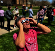 man wearing solar eclipse glasses