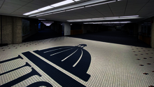 Capitol dome graphic on tiled floor in a dimly lit hallway.