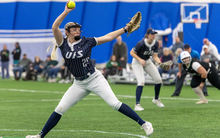 Calista Stahlhut pitching in blue UIS softball uniform