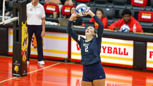 Madi Siefken playing volleyball in blue UIS uniform