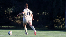 Riley Lloyd playing soccer in UIS gold