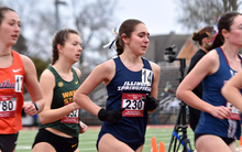 Josslyn Gaona running outdoor track in blue uis uniform