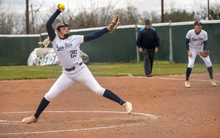 Calista Stahlhut pitching in white UIS uniform