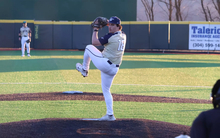 Isaac Graf  pitching in gold UIS uniform