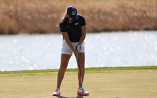 Elaine Grant golfing in blue UIS hat and polo