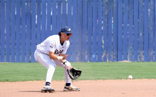 Jesse Contreras playing shortstop in white UIS baseball uniform