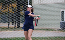 Maria Garcia Gama playing tennis in blue UIS uniform