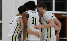 men's basketball team huddle