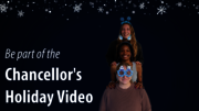 Three people stacked, wearing festive headbands, under a snowflake background.