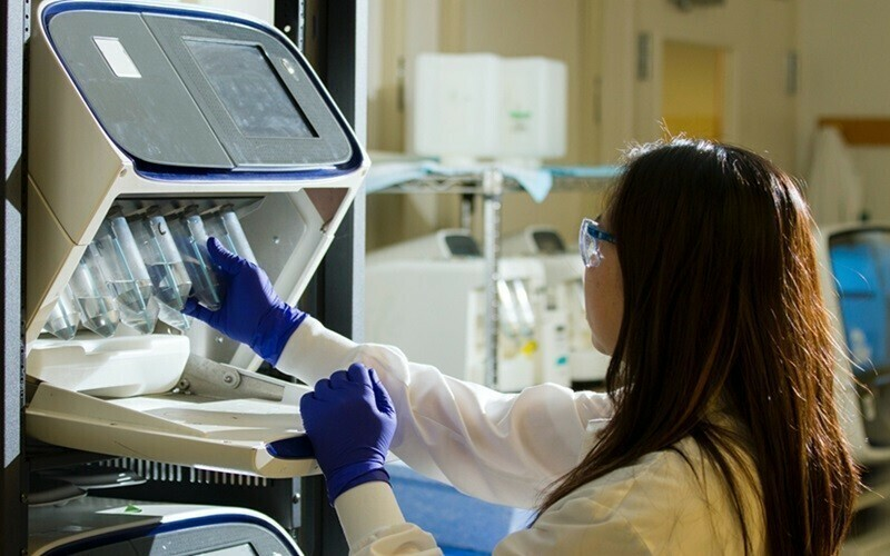 Lab Expert examining some samples in test tubes.