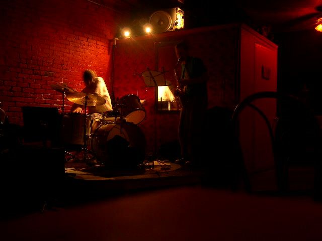 Photograph of a drummer and saxophone player