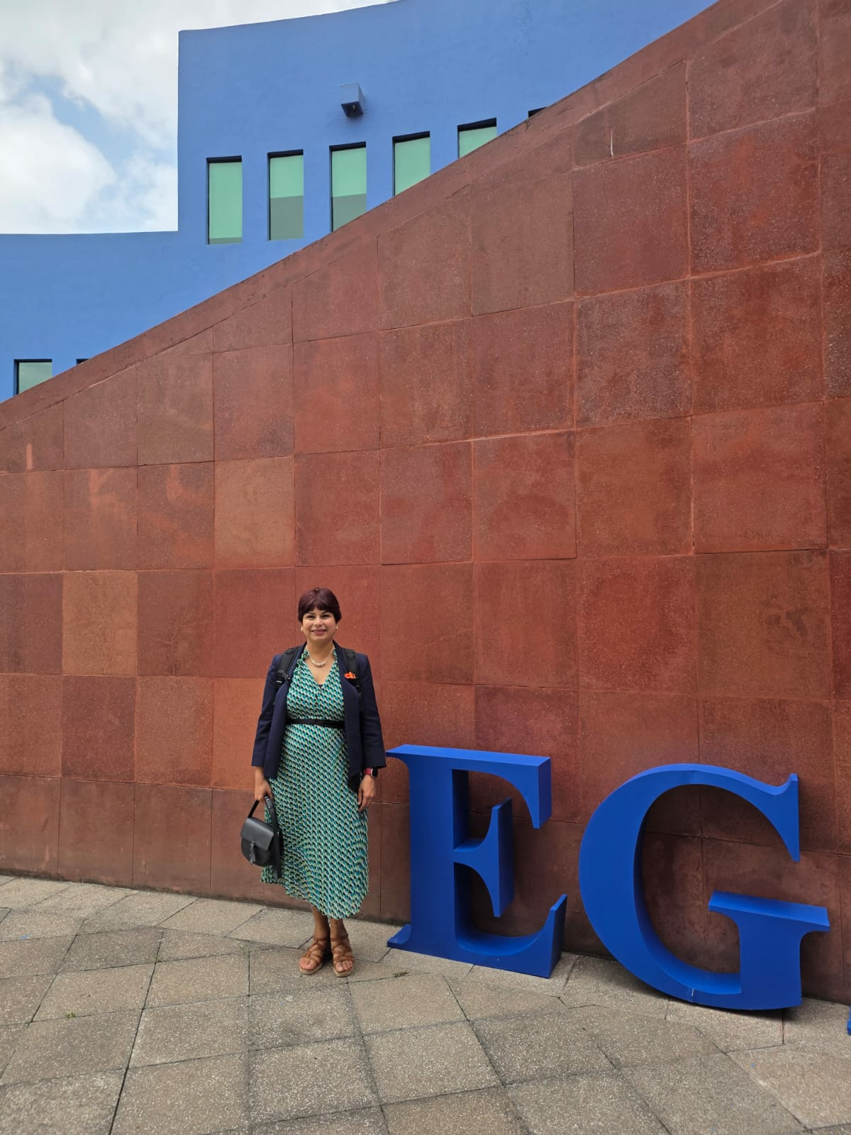 Shipra Gupta stands outside EGADE Business School near large blue letters and a modern building.