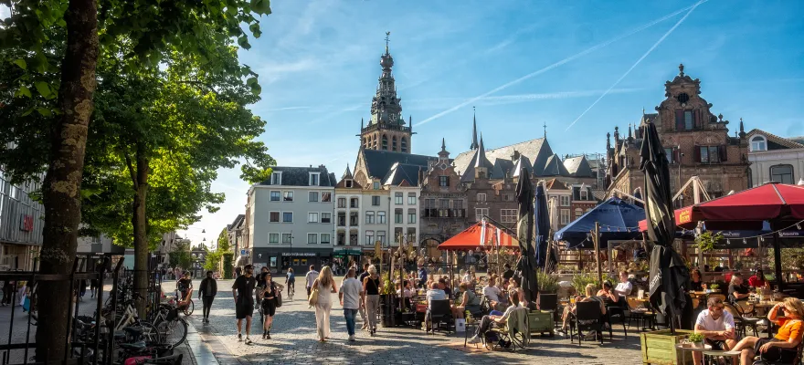 People sitting in the old town square on a sunny summer day