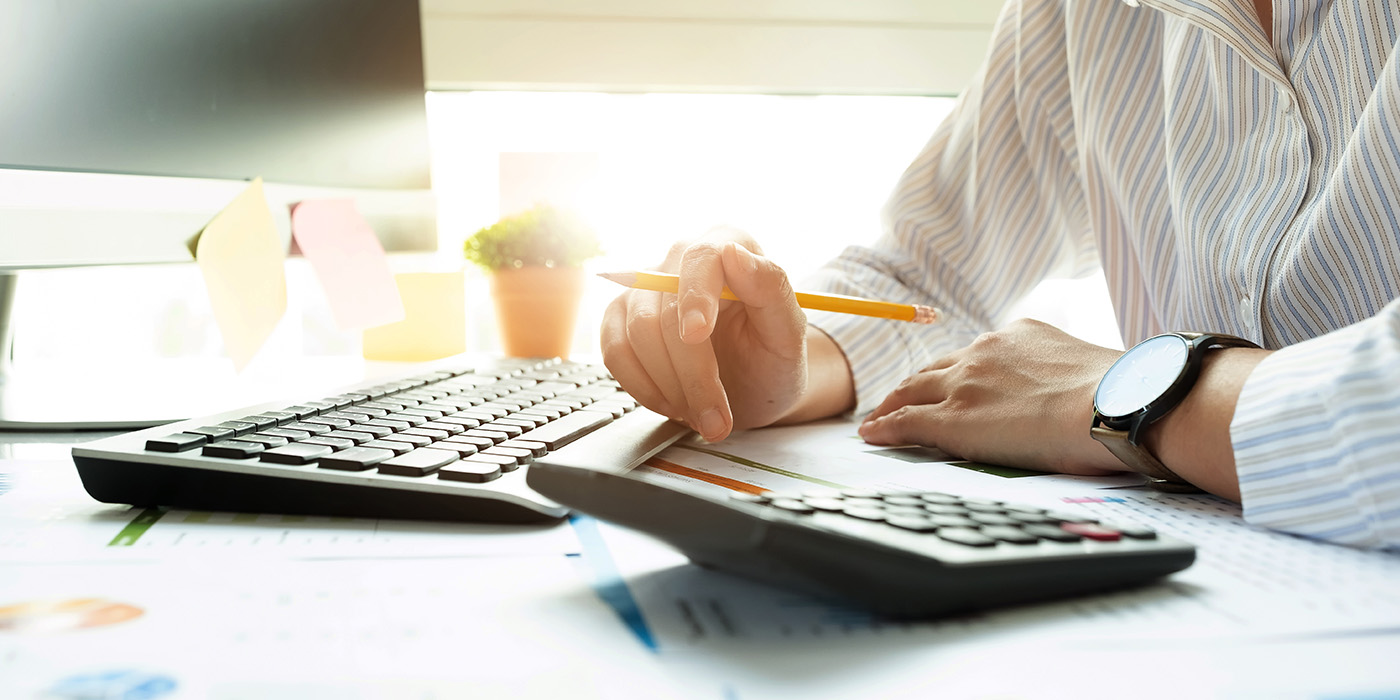 Person with keyboard and calculator