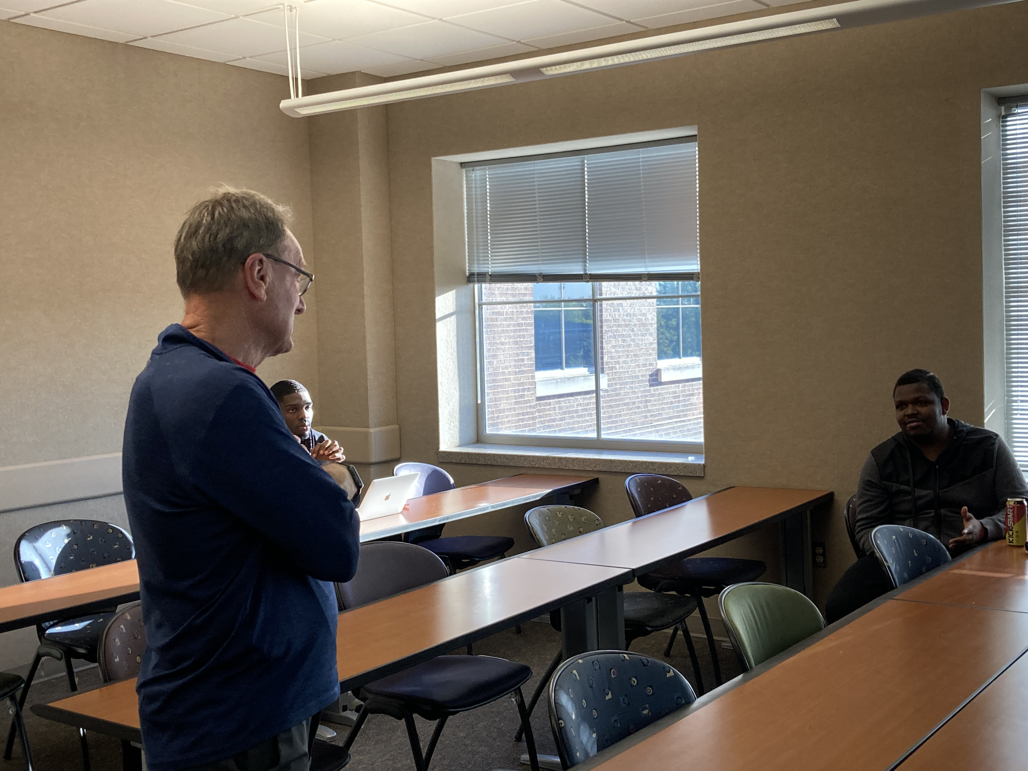 An instructor listening to a UNI 301 class.