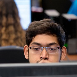 student behind computer screen