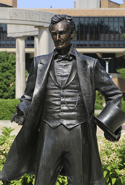 The Abraham Lincoln statue at UIS with the colonnade in the background.