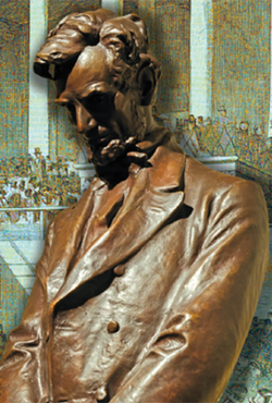 A bronze statue of Abraham Lincoln looking down.