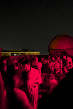 A crowd of people on the roof of Brookens Library for a Star Party.