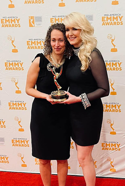 Yona Stamatis and Julie Staley holding the Emmy award.