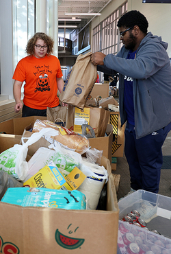 Students put collected food inside bins