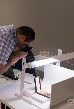 A student takes a photo of a historical artifact.