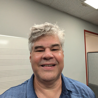 Michael Hull in blue shirt smiling