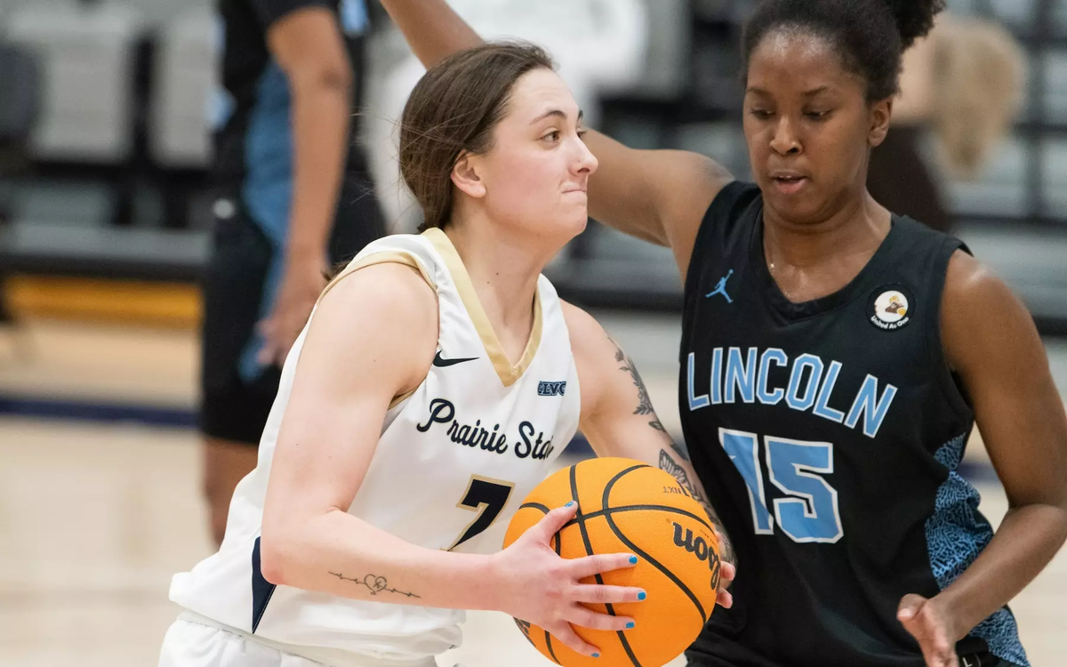 Kennedy Osterman playing basketball in white UIS uniform