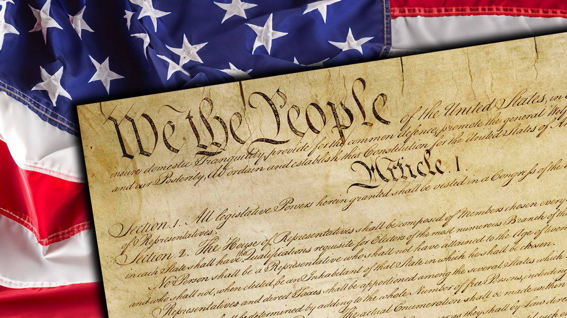 Close-up of the United States Constitution with the words “We the People” visible, placed over an American flag background.
