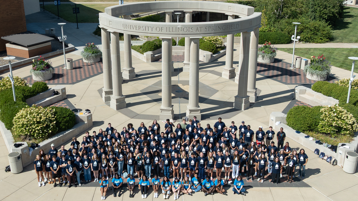 A mass group shot of the UIS Class of 2029 in front of the colonnade. 