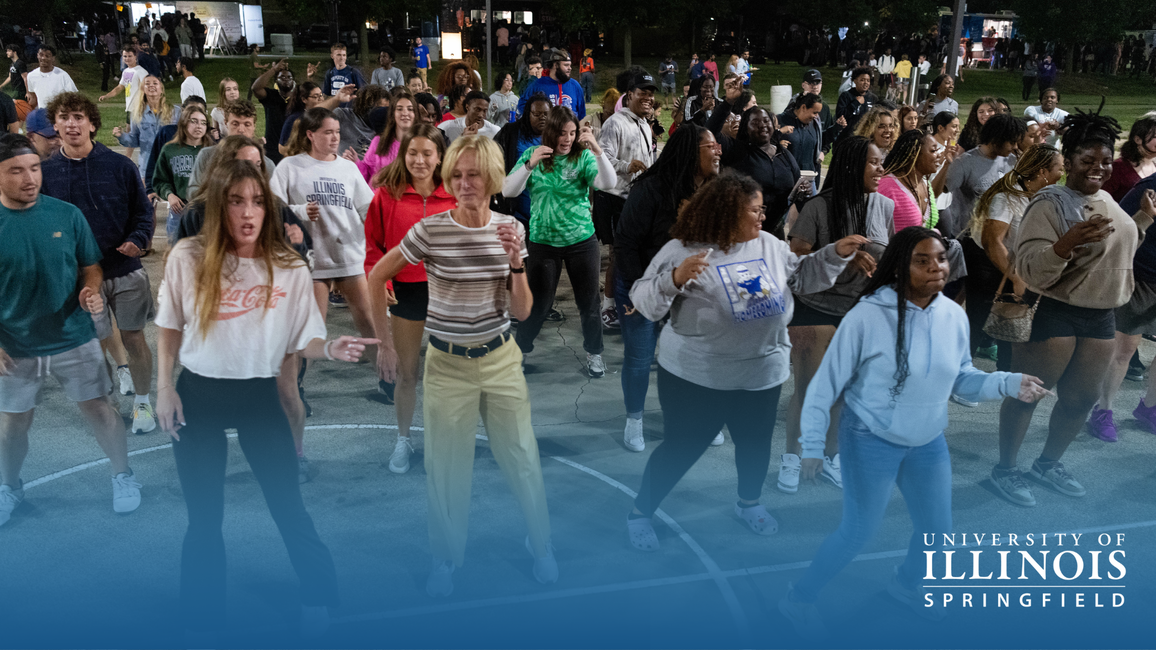 Chancellor Gooch dances with a crowd of students at RecPalooza.
