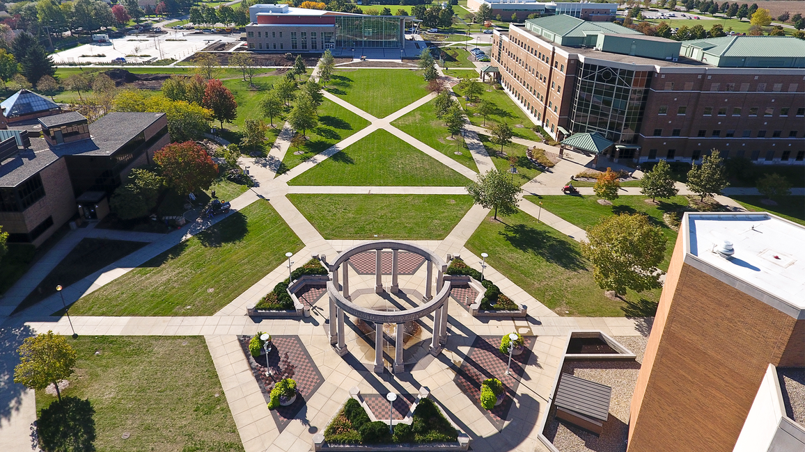 Aerial view of a campus with green lawns and modern buildings.