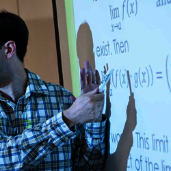 UIS math professor teaching at whiteboard