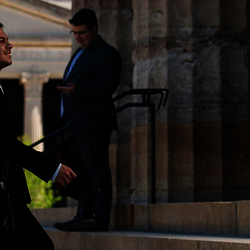 male lawmaker climbing steps of Capitol with a smile on his face
