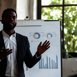 a man giving a presentation to a group of business people