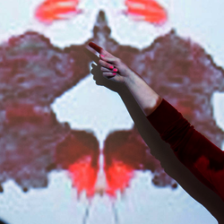psychology professor pointing to a Rorschach test on an overhead projector